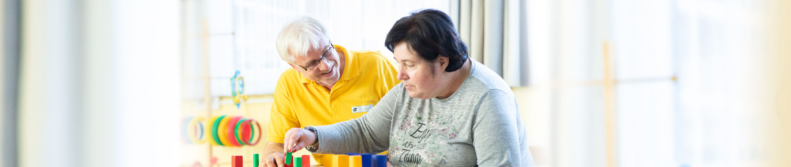 Das Bild zeigt eine Ergotherapie-Einheit mit einer Bewohnerin