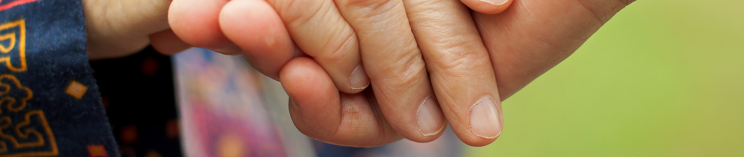 Doctor's hand holding a wrinkled elderly hand