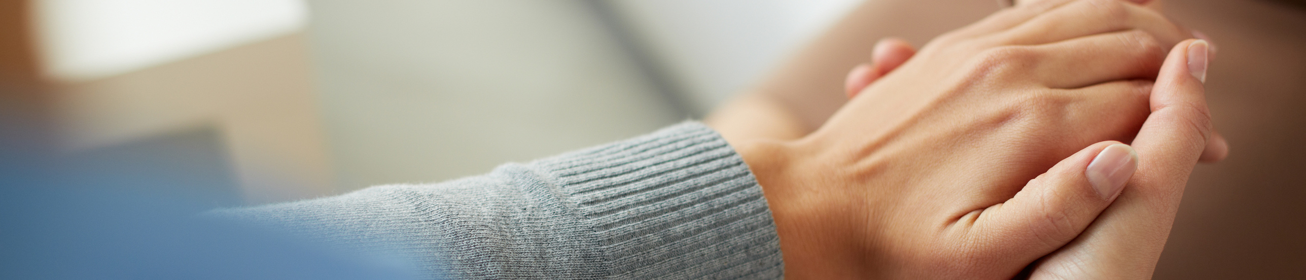 Close-up of psychiatrist hands together holding palm of her patient