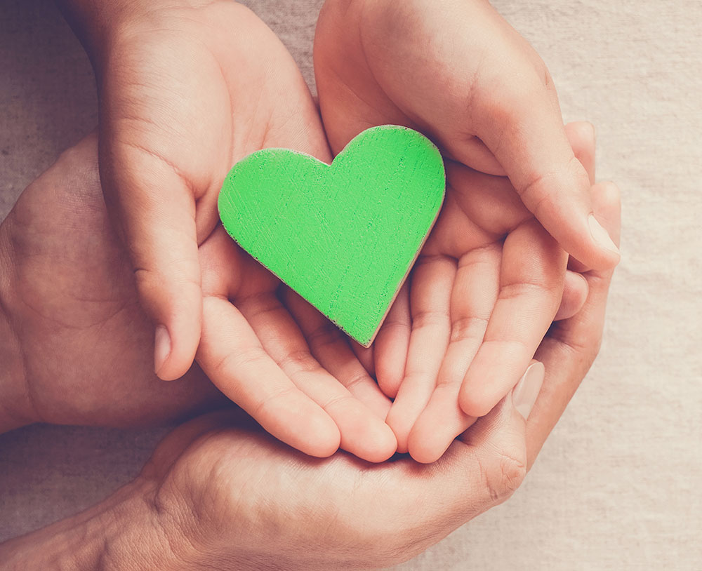 green heart with hands