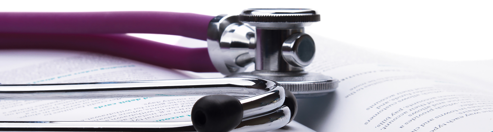 A stethoscope is lying on an open book