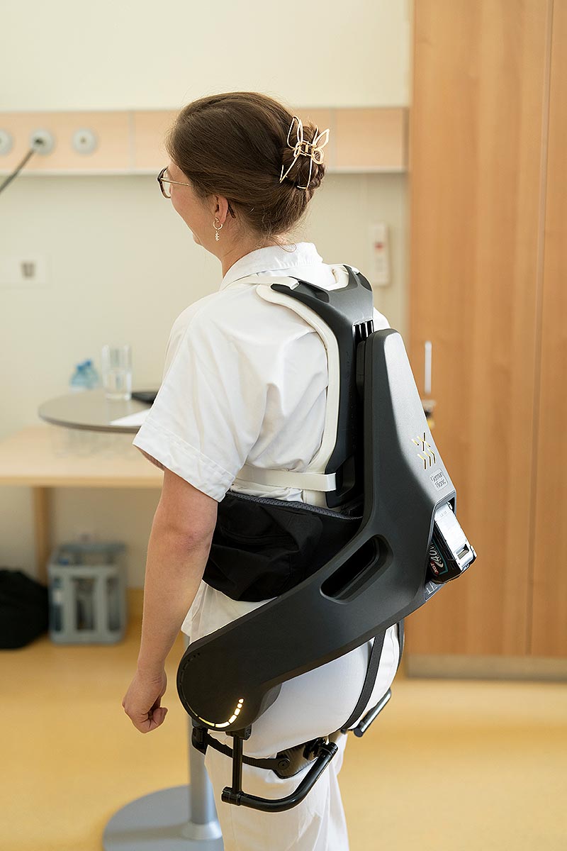 Das Bild zeigt eine Pflegeperson mit einem Exoskelett.