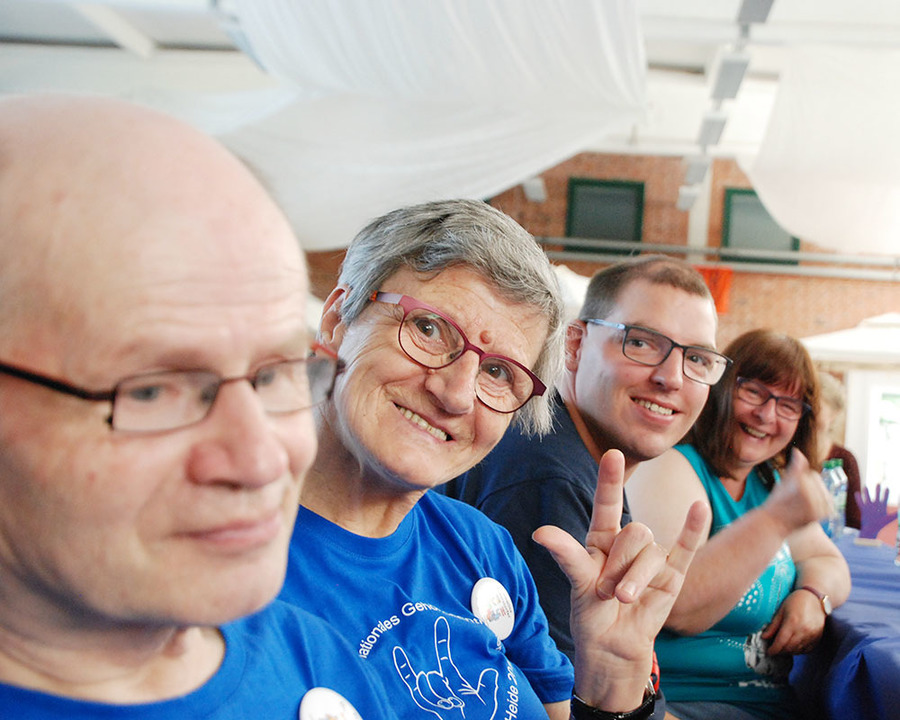 4 people smile at the camera.