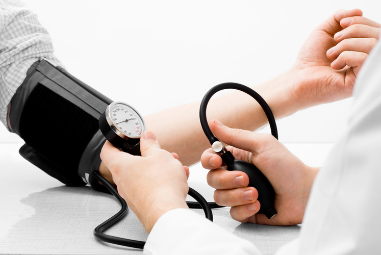 Blood pressure measuring studio shot on white background
